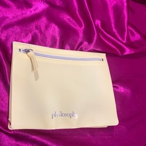 Philosophy yellow cosmetics bag.Waterproof and silicone like material.Zips close